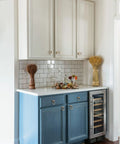 Kitchen with champagne bronze cabinet pulls, showcasing six pack modern zinc alloy finger drawer pulls on white and blue cabinets.