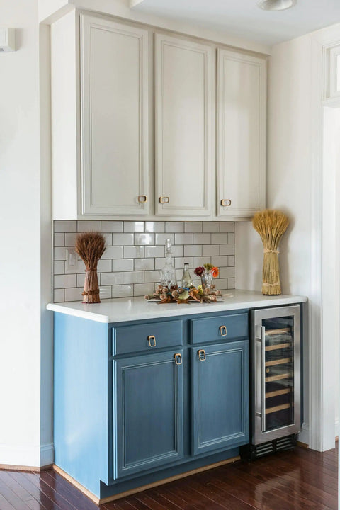 Kitchen with champagne bronze cabinet pulls, showcasing six pack modern zinc alloy finger drawer pulls on white and blue cabinets.