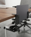 Adjustable Under Desk Laptop Holder With Integrated Cord Organizer Rack Quick Grip Edge Clamp showing laptop and power cords under desk.