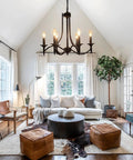 Black Farmhouse Chandelier Industrial Iron Six Light Pendant in a modern living room setting with natural light and rustic decor.