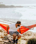 Man sitting on Mantis Ultralight Hammock With Mosquito Net And Storage Bag For All Seasons, Featherlight Levitas 20D Nylon Ripstop Fabric