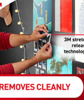 Person using Poster Strips Mega Pack Holds Up To 68 Posters With Damage Free Hangers No Tools Needed White Adhesive Ideal For Home Office Dorm Decor On Walls Doors And More on wall photo display