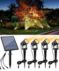 Metal Solar Spot Lights Outdoor With 9.8ft Cable Hella Bright 4 Spotlights illuminating garden trees at dusk
