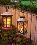 Flickering Lantern With 3 Flameless Candles, Waterproof PVC Garden Hanging Lights glowing in garden at night with plants.