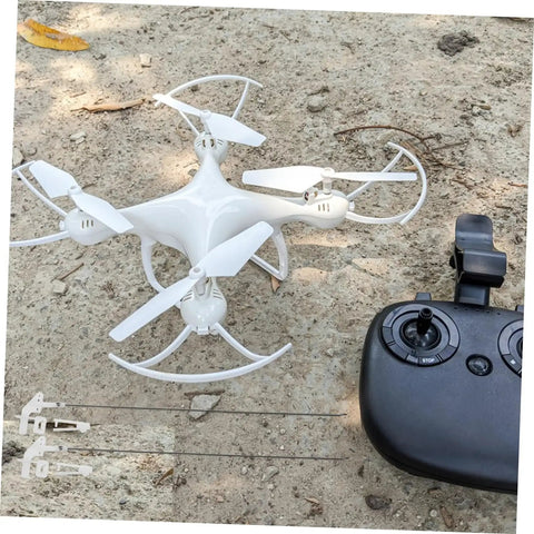 White drone with remote controller on dirt ground, image not related to 20 Sets Aircraft Control Horns and Connectors for Model Airplanes, Linkage Stopper Parts for Fixed-Wing Aircraft, Durable Metal, Easy Installation, Bulk Pack for RC Projects.