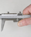 Person using Vernier Caliper 0 To 6 Inch (0 To 150 Mm) Measuring Range Satin Chrome Stainless Steel with Fine Graduation.