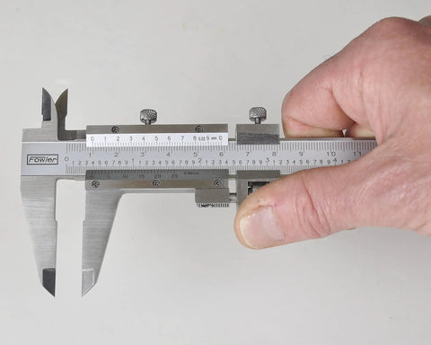 Person using Vernier Caliper 0 To 6 Inch (0 To 150 Mm) Measuring Range Satin Chrome Stainless Steel with Fine Graduation.