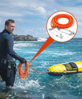 Spearfishing Float Line 100 Ft Orange Foam Filled Braided Polypropylene Tow Rope Pro Grade One Quarter Inch Diameter With Five Point Nine Inch Rotating Stainless Clamps And Stainless Hooks in use by diver next to yellow float at sea.