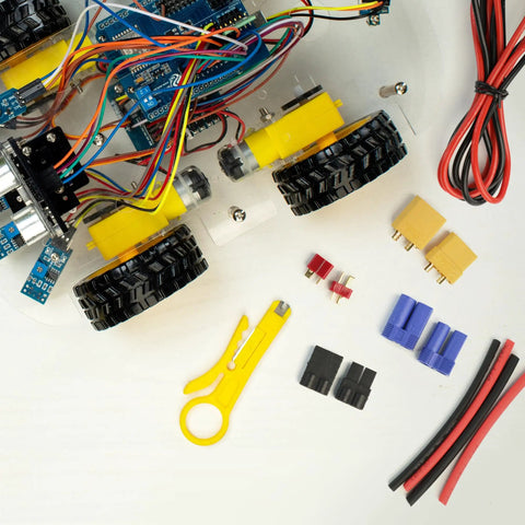 RC Battery Connector Adapters Pack With T Plug EC3 XT30 XT60 Male And Female Adapters 14 AWG Silicone Wire And Heat Shrink Tubing 62 Pack For ESCs And LiPo Battery Motors laid out next to a robotic vehicle with wiring and tools.