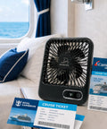 Slick Portable Cruise Fan With Tight Grip Magnetic Mount For Cabin Walls Or Ceiling, 4000 Mah Battery, Usb Rechargeable, Five Adjustable Speeds, Smart Timer And Clean White Noise placed beside cruise tickets on a bed.