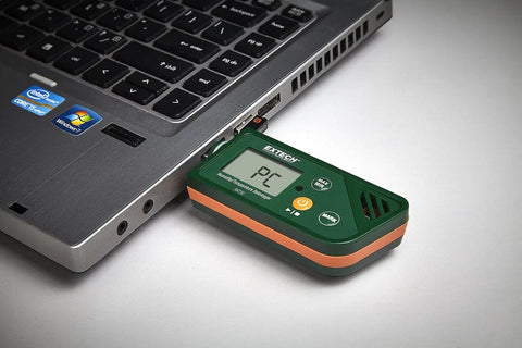 USB Humidity And Temperature Datalogger With SD Card Storage And Excel Export connected to laptop for data transfer.