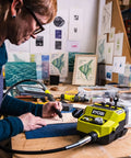 Person using Badass 18 Volt Cordless Mini Rotary Tool With 35 Premium Accessories For Ultra Fast Diy Engraving Polishing And Precision Sanding Projects A Top Shelf Pick For Any Weekend Warrior Crafting Kit on wood.