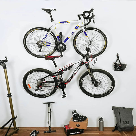 Wall Mounted Bike Pedal Hook Rack For Indoor Storage And Garage Organization With Tire Brackets Space Saving Hanger To Hold Three Bikes At A 45 Degree Angle No Handlebar Turning installed on white wall with two bikes mounted