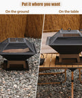 Compact 19.8 Inch Square Fire Pit With Removable Ash Pan And Mesh Lid on ground and table, outdoor fireplace
