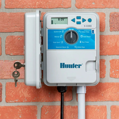 XC400 4 Zone Outdoor Sprinkler Controller With Weather Resistant Irrigation Timer for Lawn and Garden mounted on brick wall
