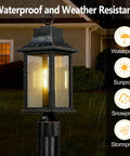 Dusk to Dawn Outdoor Post Light 19.29 Inch Matte Black Lamp Post With Pier Mount, shown lit in rainy weather, close-up view