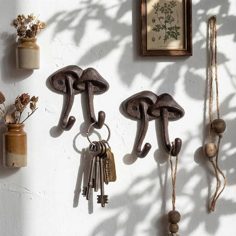 Straight Up Legit Mushroom Wall Hooks Set Of Two Heavy Duty Cast Iron Coat Hangers With Antique Black Finish, holding keys.