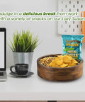 Premium 12 Inch Acacia Wood Lazy Susan Rotating Tray With Four Removable Dividers holding snacks on a desk.