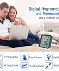 Digital Indoor Hygrometer Thermometer With Touchscreen 4Inch Large Display Easy Readings And Front Button Operation High Accuracy Humidity And Temperature Monitor For Home Or Your Pad. White and grey digital indoor hygrometer on a table