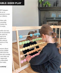 Natural Pine Wood Foldable Baby Playpen With 10 Expandable Panels And Built In Jumbo Activity Toys Tot Approved Setup seen from outside with child playing.
