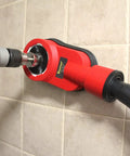 Universal Drilling Dust Shroud With Vacuum Suction for clean wall drilling with grey rotary hammer attached to red shroud.