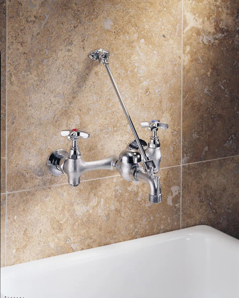 Rugged 8 Inch Center Wall Mount Service Sink Faucet With Two Handles, Low Arc, Brass Construction in rough chrome finish on tiled wall.