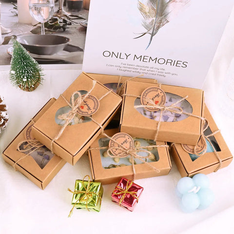 Brown Soap Boxes With Clear Window 32 Pack In 4 Shapes laid out decoratively with jute twine, ideal for gifts.