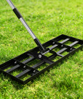 Heavy Duty Stainless Steel Lawn Leveling Rake With 30x10 Inches Head and 76 Inch Adjustable Handle on grass