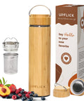 Premium 17 Oz Bamboo Tea Tumbler With Removable Loose Leaf Infuser next to fresh fruit and metallic infusers, showcasing eco-friendly design.