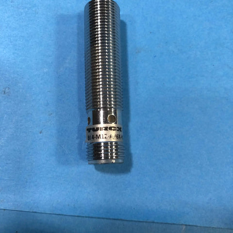 Inductive Proximity Sensor M12 Eurofast Male 12mm Round 4mm Sensing Range 4 Pin PNP Normally Open, metal body in blue background