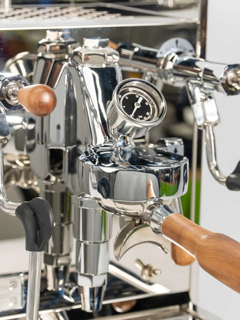 Pro Grade Dual Boiler Espresso Maker With PID Precision Tuning hardened stainless frame, detailed view showing portafilter and gauge.