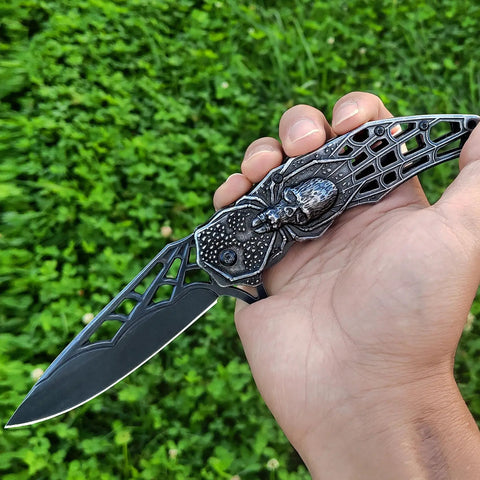 Close-up of Pocket Folding Knife With 3D Embossed Skull Pattern, 3.6 Inch Razor Sharp 440 Stainless Steel Blade in a hand.
