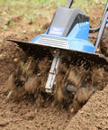 Powerful 16 Inch Corded Garden Tiller Cultivator With A Thirteen Point Five Amp Motor 6 Steel Tines in action on garden soil