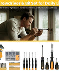 Man using screwdriver from a set to fix door lock; includes multiple screwdrivers and bits for home repairs.