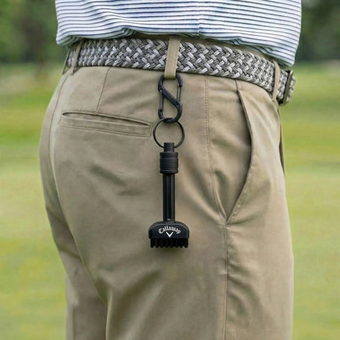Mini-Mag Magnetic Club Brush for Golf clipped to golfer's belt, compact quick release handle visible.