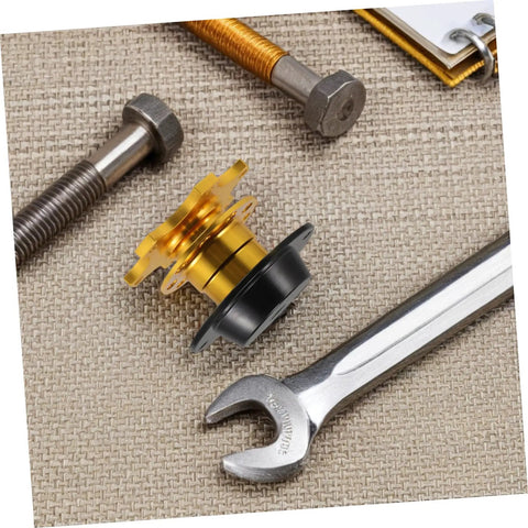 Quick Release Steering Wheel Hub Adapter For Racing Cars, gold and black finish, with tools on a textured surface
