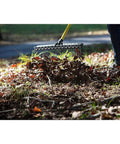 Heavy-Duty 55-Inch Fiberglass Rake With A 21-Inch Steel Tined Head For De-Thatching And Landscaping in use on a lawn