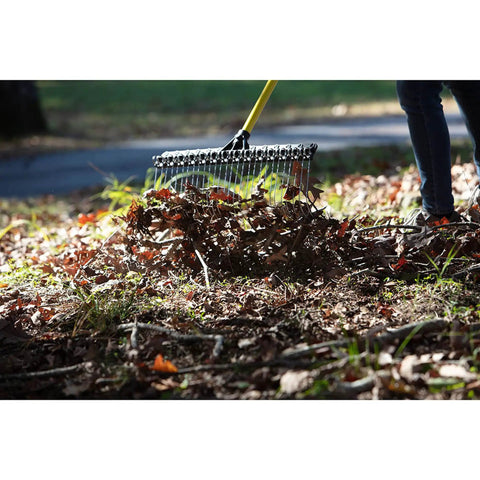Heavy-Duty 55-Inch Fiberglass Rake With A 21-Inch Steel Tined Head For De-Thatching And Landscaping in use on a lawn