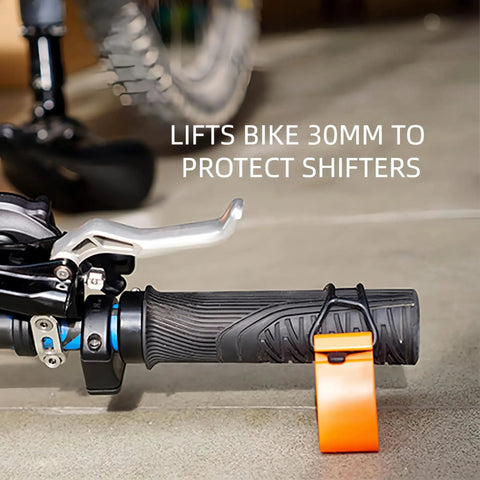 Clip On Bike Stabilizer And 30mm Elevation Tool with no slip rubber straps on black handlebar, orange accessory.