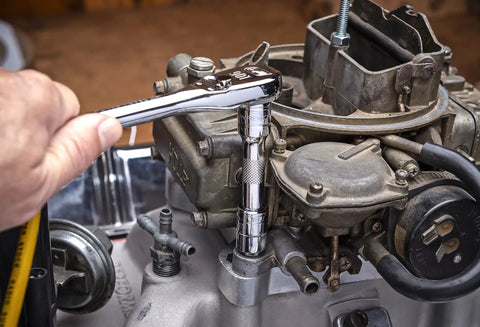 Mechanic using 11 Piece Wobble Extension Set With Ball Detent For Secure Socket Retention on engine component in workshop.