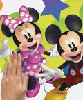 Person applying Disney Mickey And Friends Giant Peel And Stick Wall Decals With Personalization 116 Piece Set Includes Alphabet Letters For Custom Name Removable And Repositionable No Residue On Smooth Surfaces Great For Kids Rooms to wall