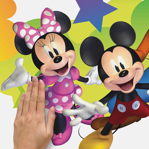 Person applying Disney Mickey And Friends Giant Peel And Stick Wall Decals With Personalization 116 Piece Set Includes Alphabet Letters For Custom Name Removable And Repositionable No Residue On Smooth Surfaces Great For Kids Rooms to wall