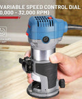 Hand holding Compact Wood Router Kit With 6.5 Amp 1.25 HP Power 32000 RPM Handy Beginner Friendly DIY Trim Router indoors.