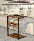 Two Tier Computer Tower Stand With Charging Station next to a couch in living room, showing wood finish and metal frame.