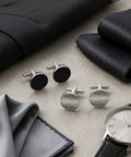 Two Pair Silver Plated French Cufflinks For Men Highlighting Smooth Black Enamel Disks and Crisp Grid Mesh Patterns on grey surface.