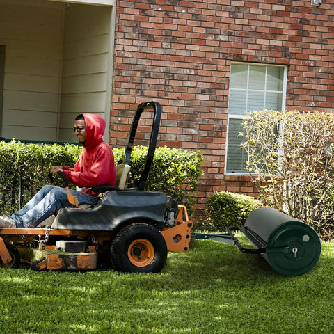 Beast Of A Lawn Roller For Yard And Garden Push Or Tow Behind 30 Gallon Water Sand Filled Sod Roller Drum attached to a tractor