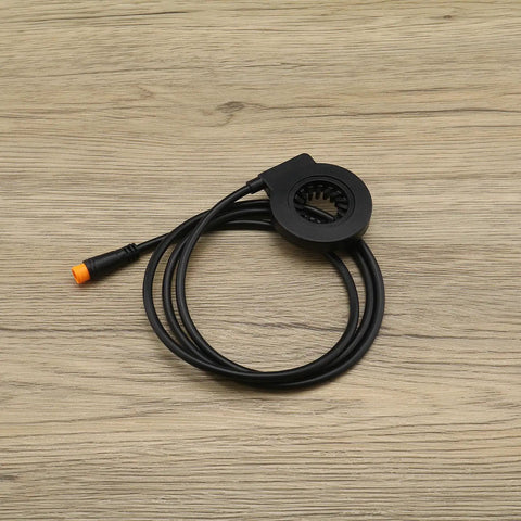 3 Pin KT V12L Electric Bicycle Pedal Assist Sensor Magnets For Left Crank Installation, coiled on wooden background