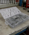 Noteflora 200 Piece Compression And Extension Springs Assortment Kit With Labeled Storage Box For Auto Repair, Machinery Fixin', Home Maintenance Projects And General Toolbox Needs To Get The Job Done Right. open labeled plastic box with assorted metal springs on workbench
