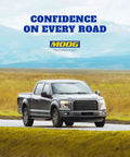 Black pickup truck driving on rural road with mountains in background, MOOG logo and slogan "Confidence on Every Road" above.