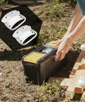 Person fitting 2 Pack Heavy Duty Chest Handles Zinc Plated Case Pull Handles onto toolbox in outdoor setting, emphasizing easy lifting and durability